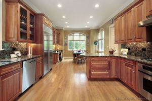 baltic brown granite countertop with medium wood cherry cabinets ands light oak flooring